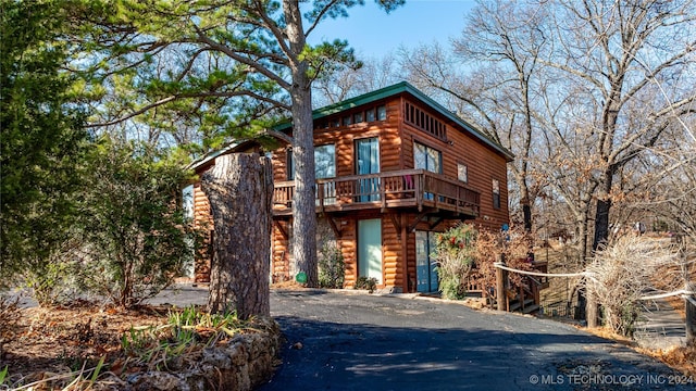 log-style house with a deck