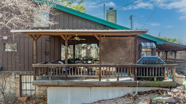 rear view of house featuring a wooden deck