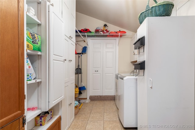 washroom featuring washing machine and dryer and light tile patterned floors