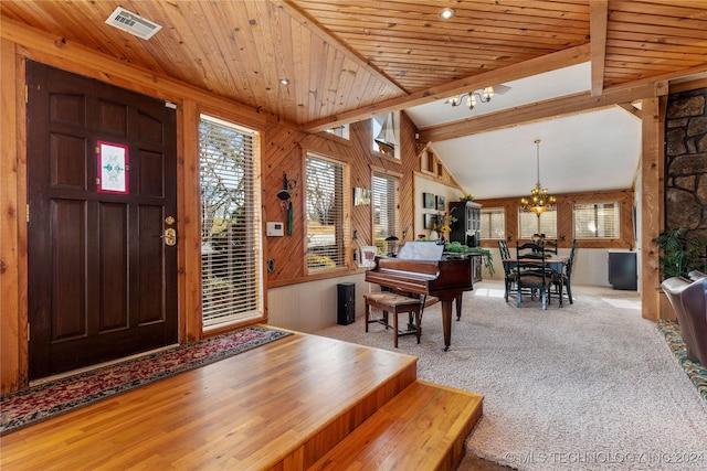 carpeted entryway with wood ceiling, vaulted ceiling with beams, wooden walls, and a chandelier