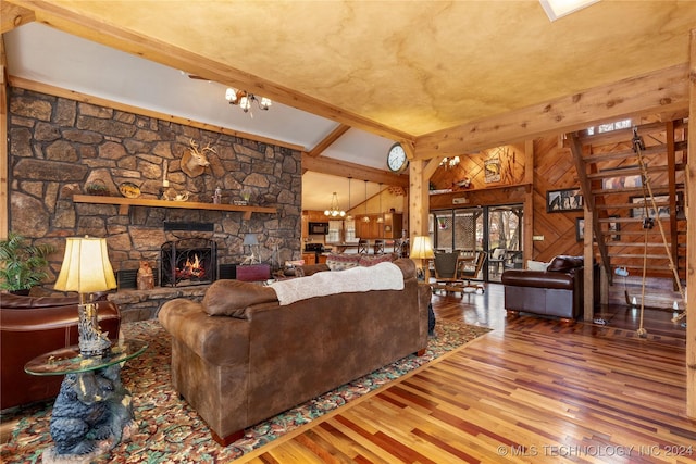 living room with a fireplace, lofted ceiling with beams, hardwood / wood-style flooring, and wood walls