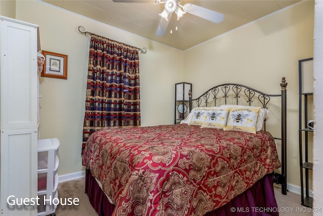 carpeted bedroom with ceiling fan and crown molding