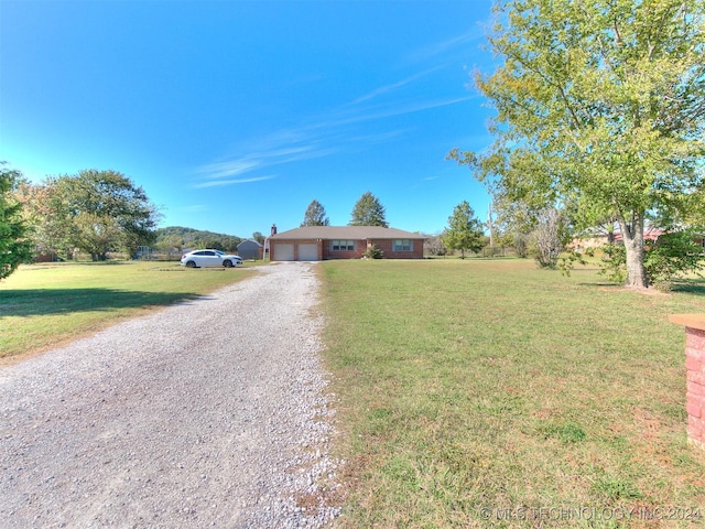 single story home with a garage and a front yard