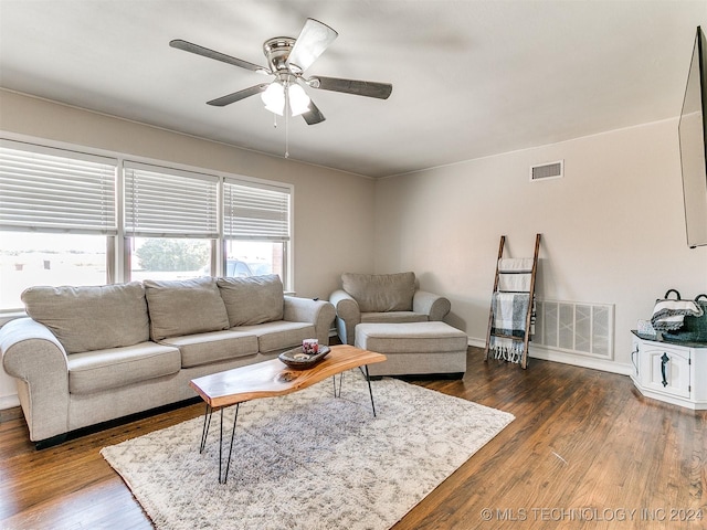 living room with ceiling fan and dark hardwood / wood-style flooring