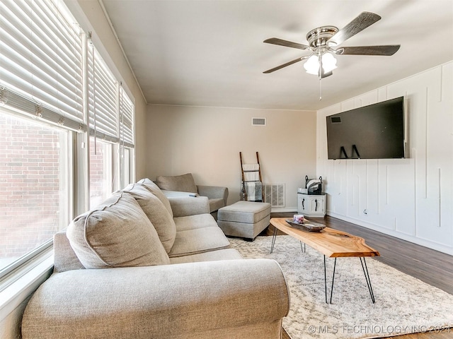 living room with ceiling fan and wood-type flooring