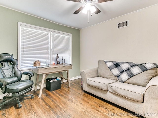 home office with ceiling fan, ornamental molding, and hardwood / wood-style flooring