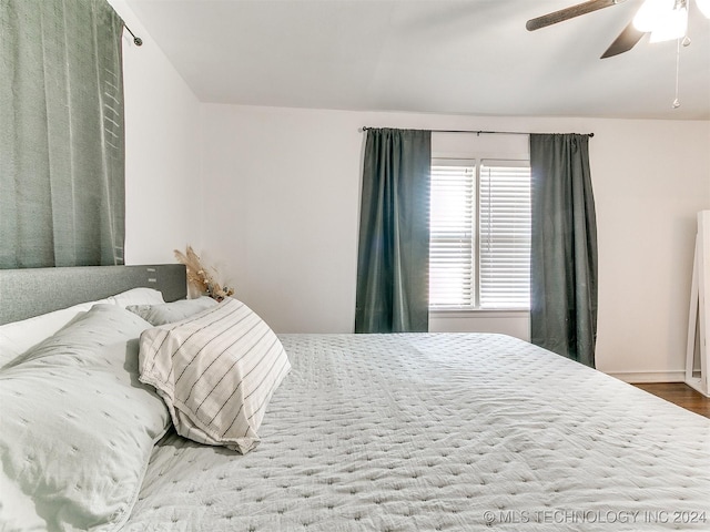 bedroom with ceiling fan and hardwood / wood-style floors