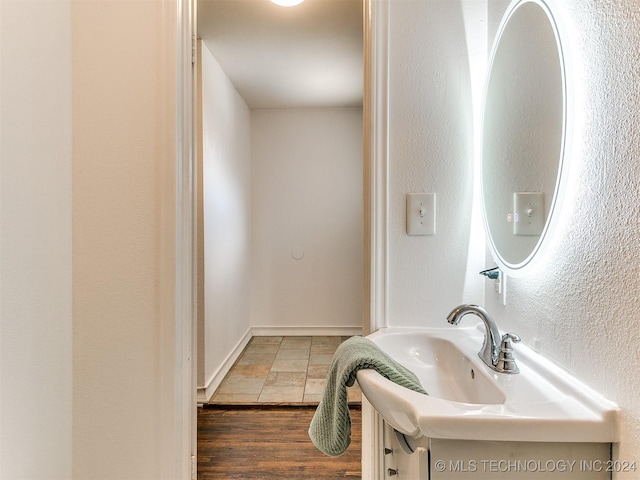 bathroom with hardwood / wood-style floors