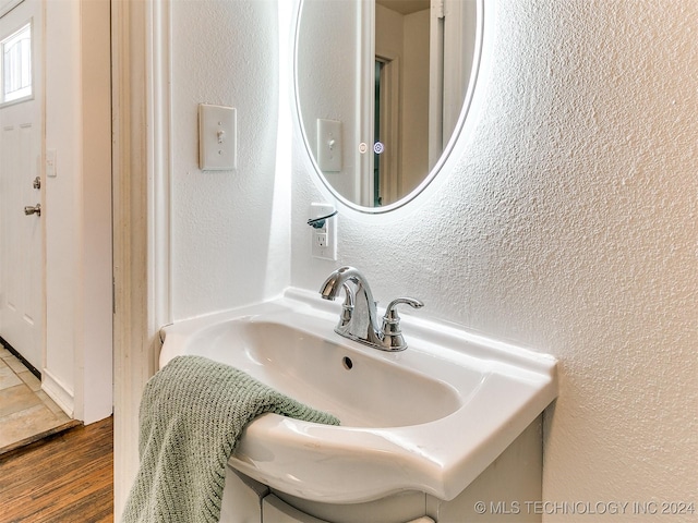 bathroom with hardwood / wood-style floors