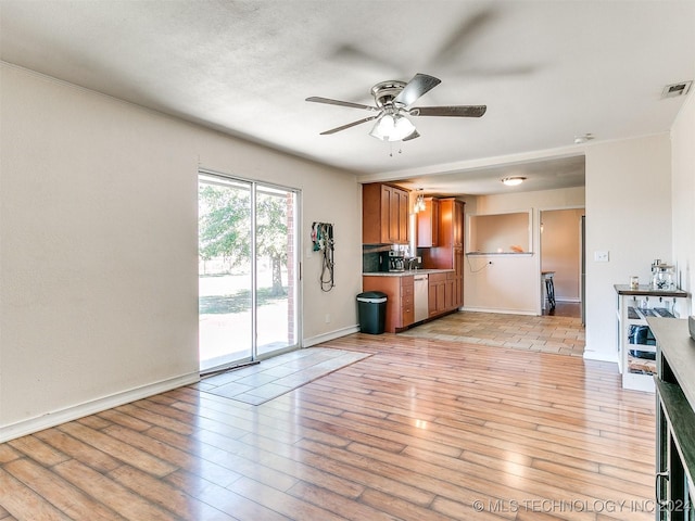 kitchen featuring stainless steel dishwasher, ceiling fan, and light hardwood / wood-style floors