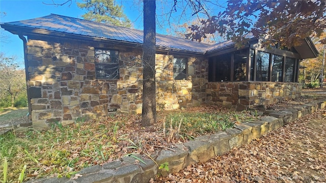 view of side of property with a sunroom