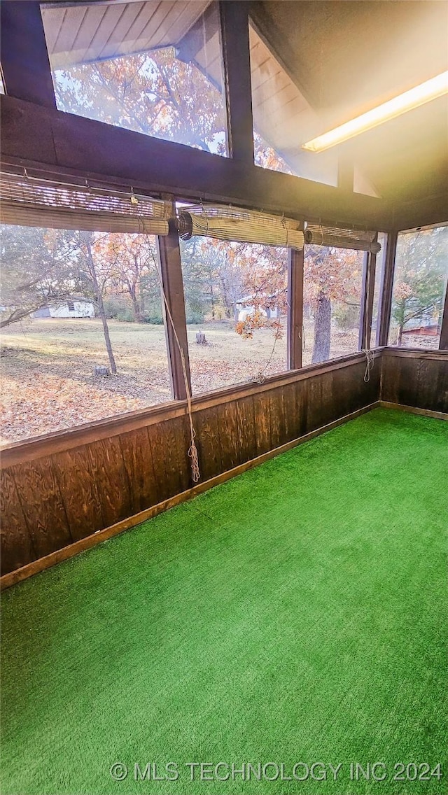 unfurnished sunroom featuring lofted ceiling