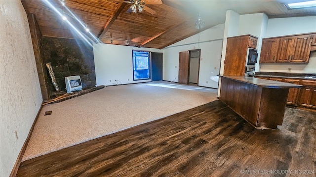 kitchen with dark wood-type flooring, ceiling fan, black microwave, heating unit, and wooden ceiling