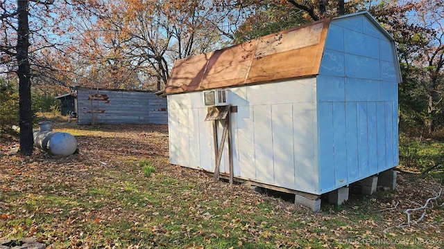 view of outbuilding featuring a wall mounted air conditioner