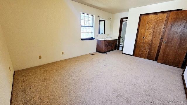 unfurnished bedroom featuring light carpet