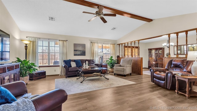 living room featuring lofted ceiling with beams, light wood-type flooring, and ceiling fan with notable chandelier