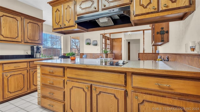 kitchen featuring black electric stovetop and light tile patterned flooring