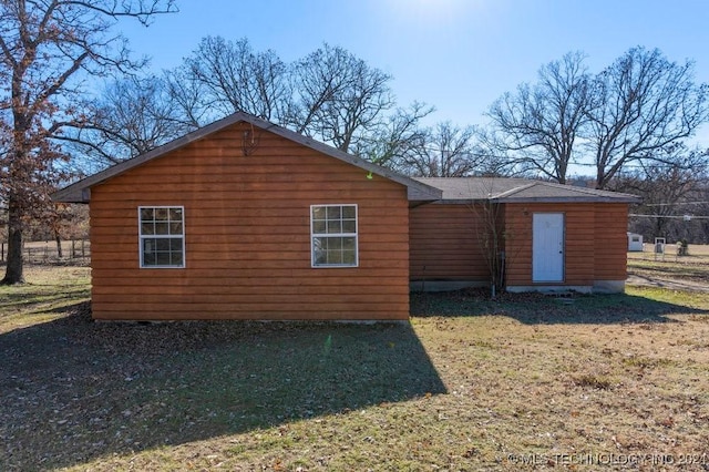 view of side of property featuring a yard