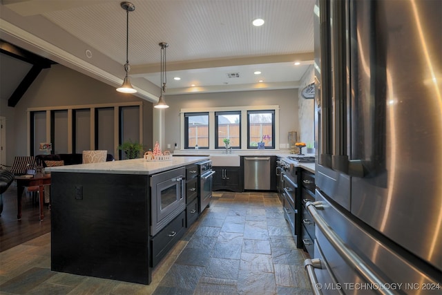 kitchen featuring pendant lighting, lofted ceiling with beams, sink, a kitchen island, and stainless steel appliances