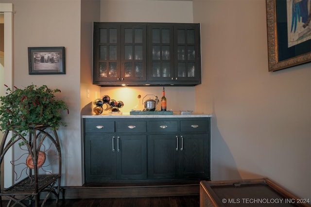 bar with dark hardwood / wood-style floors