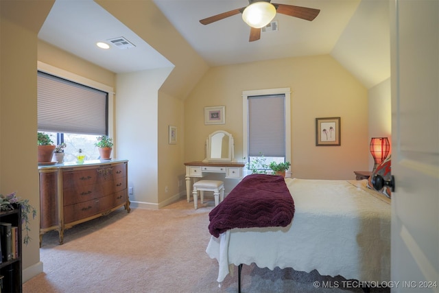 bedroom with ceiling fan, light colored carpet, and lofted ceiling