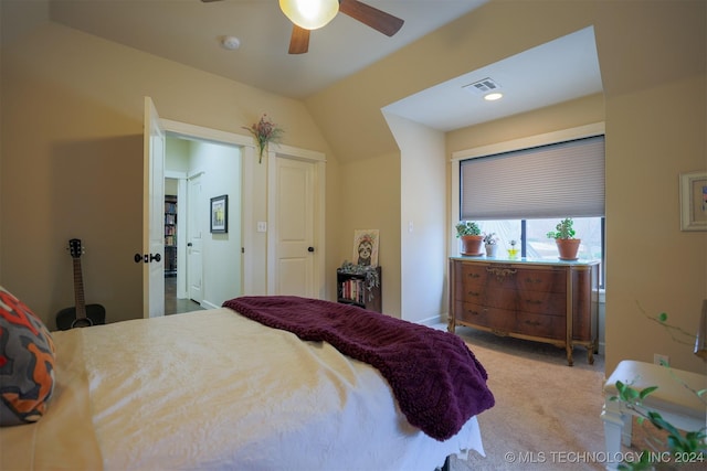 carpeted bedroom featuring vaulted ceiling and ceiling fan