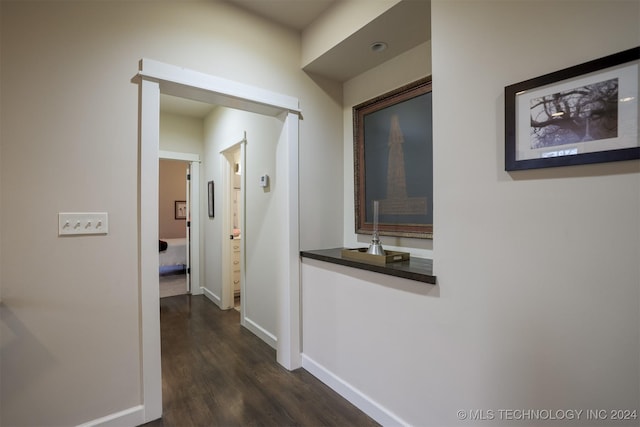 corridor with dark hardwood / wood-style flooring