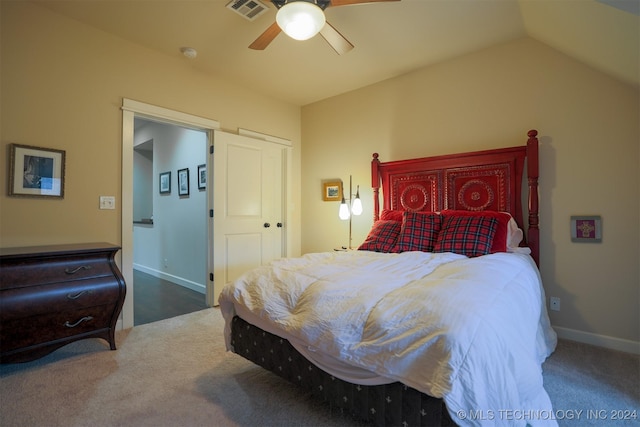 bedroom featuring dark colored carpet, vaulted ceiling, and ceiling fan