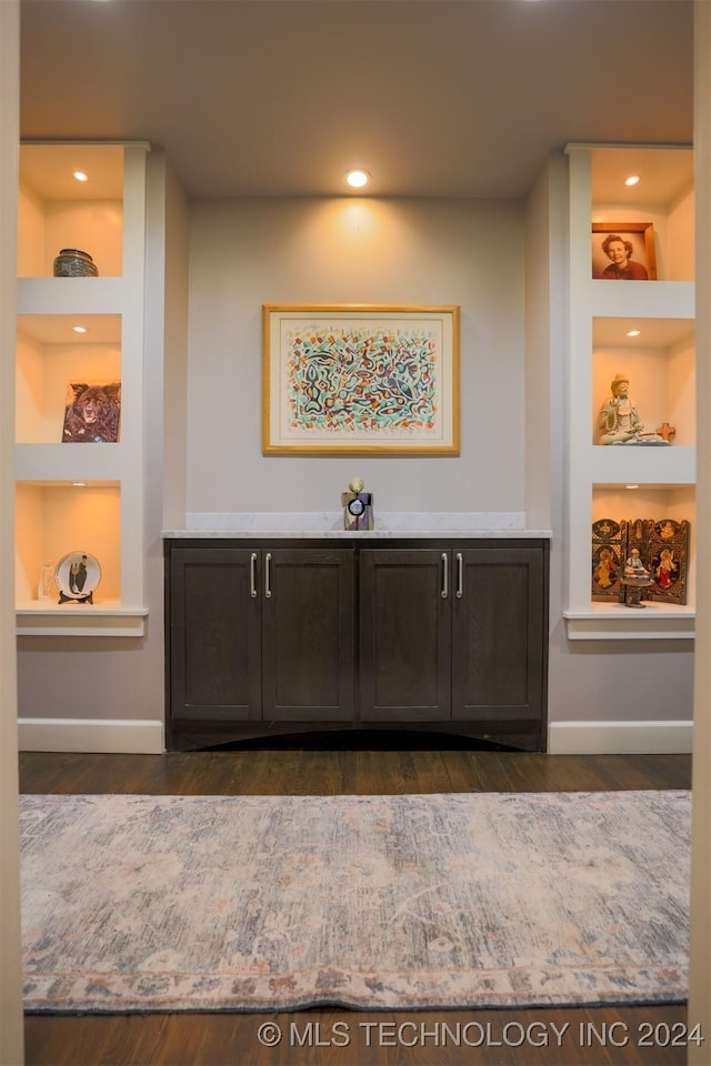 interior space with hardwood / wood-style floors and built in shelves