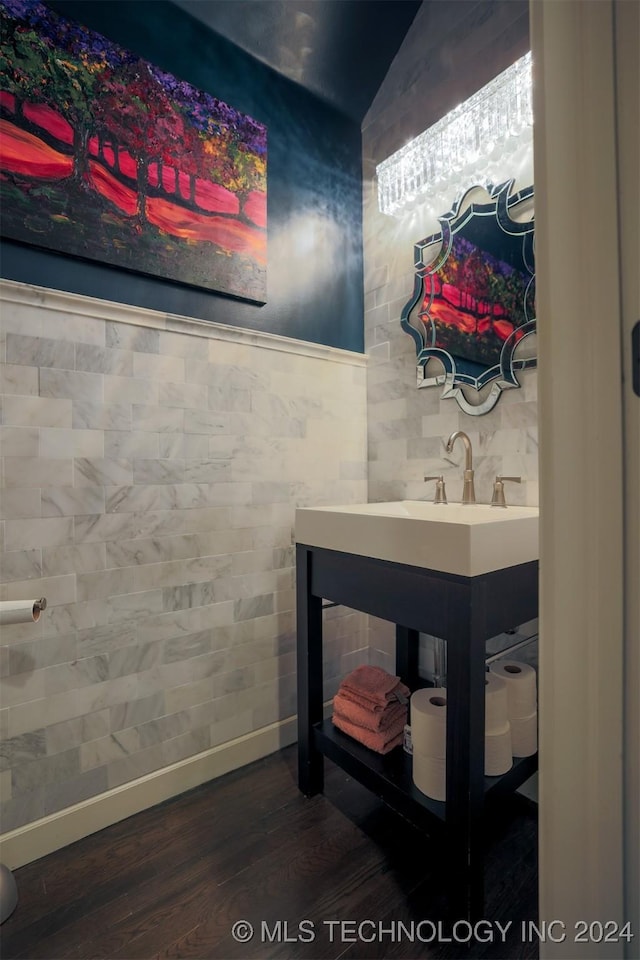 bathroom featuring hardwood / wood-style floors and tile walls