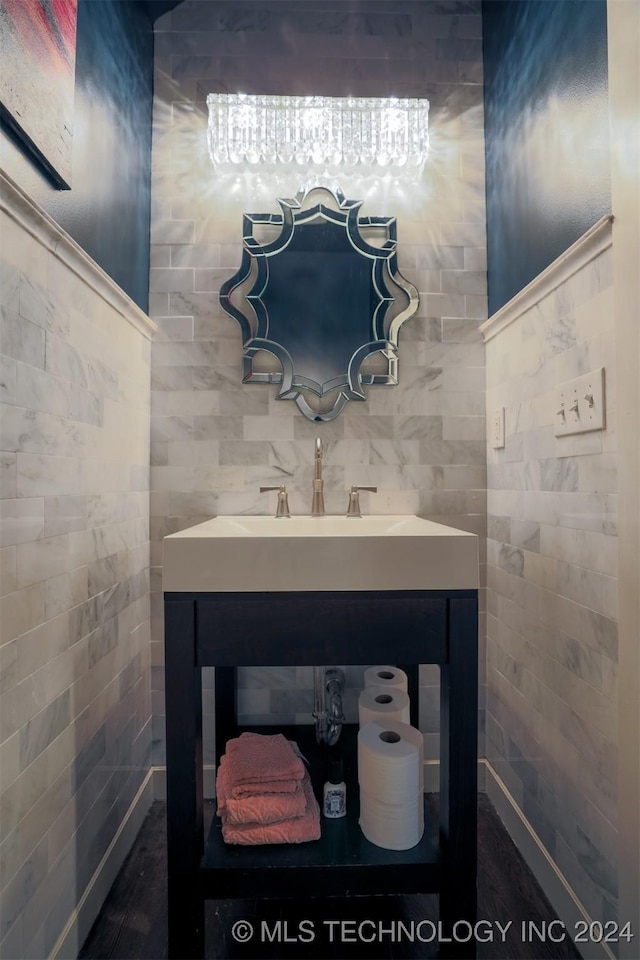 bathroom featuring vanity and tile walls