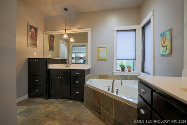 bathroom featuring vanity and tiled bath