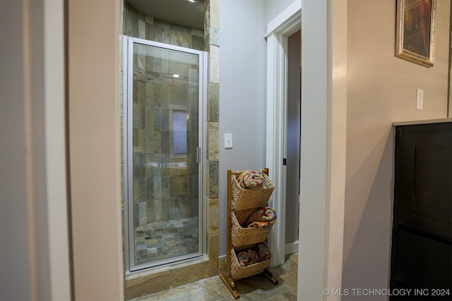 bathroom featuring a shower with door