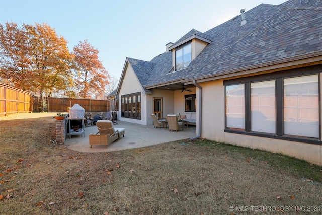 back of house with an outdoor living space, a yard, and a patio area