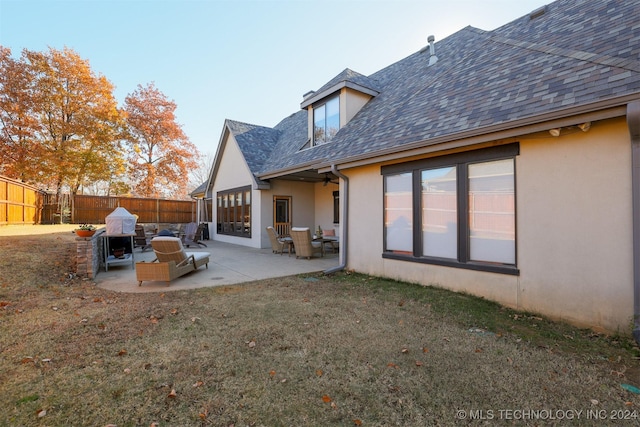 back of house featuring a yard and a patio