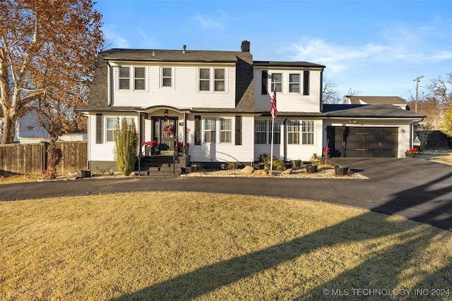 view of front of house featuring a garage and a front lawn