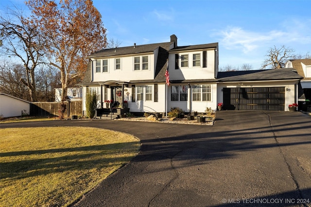 front facade featuring a front yard and a garage