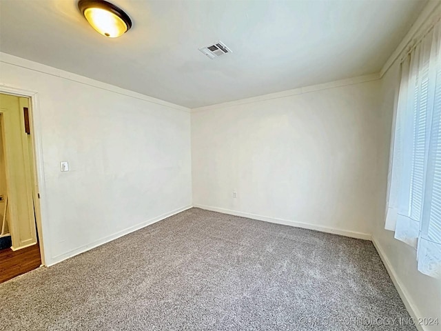 carpeted empty room with crown molding