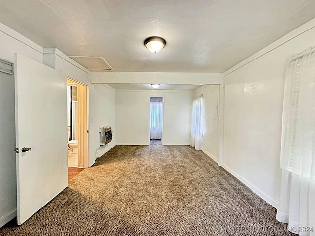 spare room featuring carpet flooring and heating unit