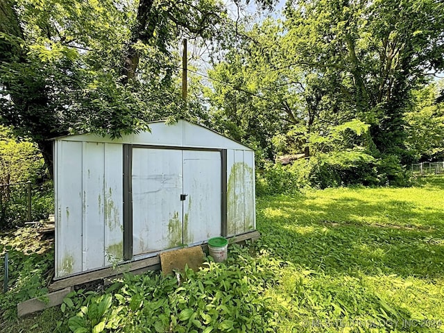 view of outbuilding featuring a lawn