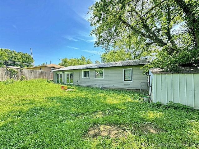 rear view of house featuring a lawn