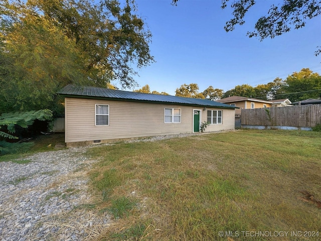 rear view of house featuring a lawn