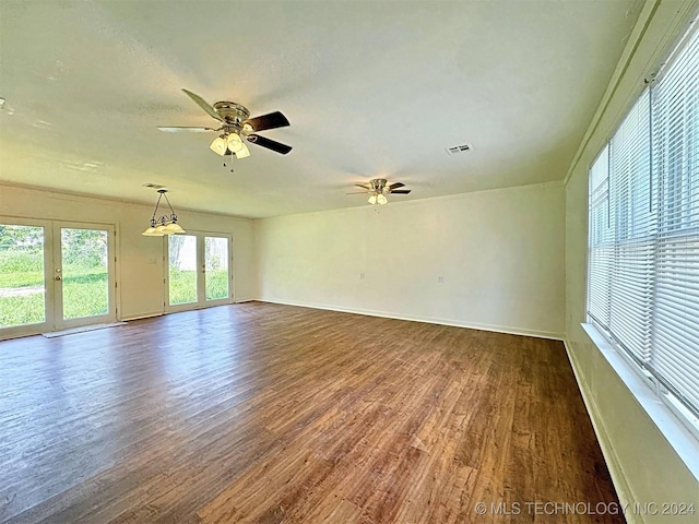 unfurnished room featuring french doors, ceiling fan, and dark wood-type flooring