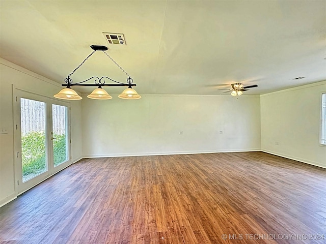 empty room with ceiling fan, crown molding, and wood-type flooring