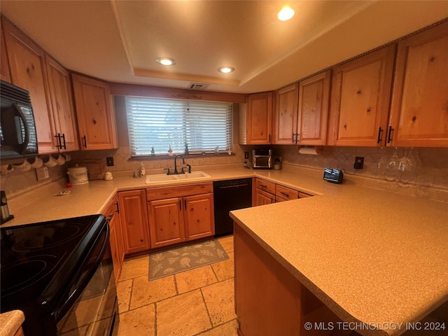 kitchen featuring decorative backsplash, sink, a tray ceiling, and black appliances