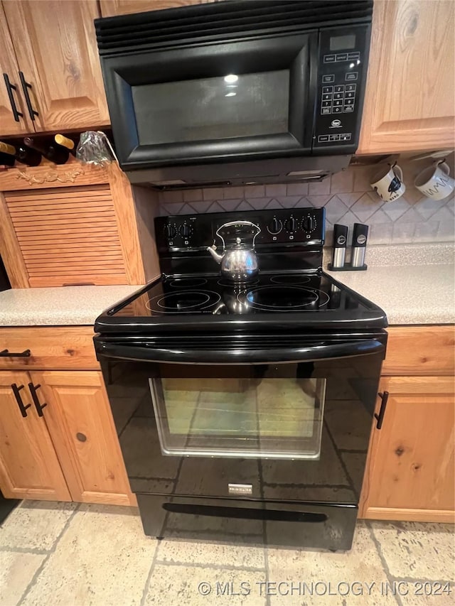 kitchen featuring backsplash and black appliances