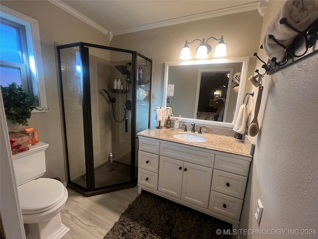 bathroom featuring walk in shower, vanity, crown molding, hardwood / wood-style flooring, and toilet