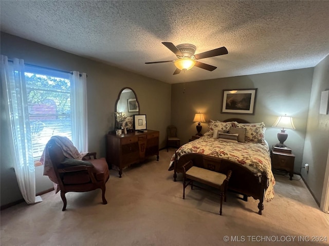 bedroom with light carpet, a textured ceiling, and ceiling fan