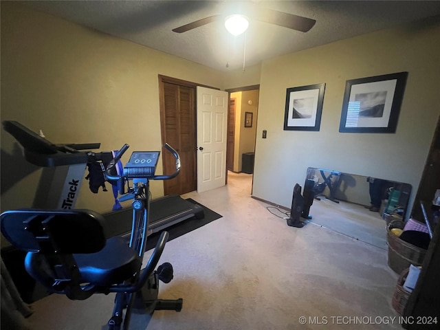 exercise room featuring ceiling fan and a textured ceiling