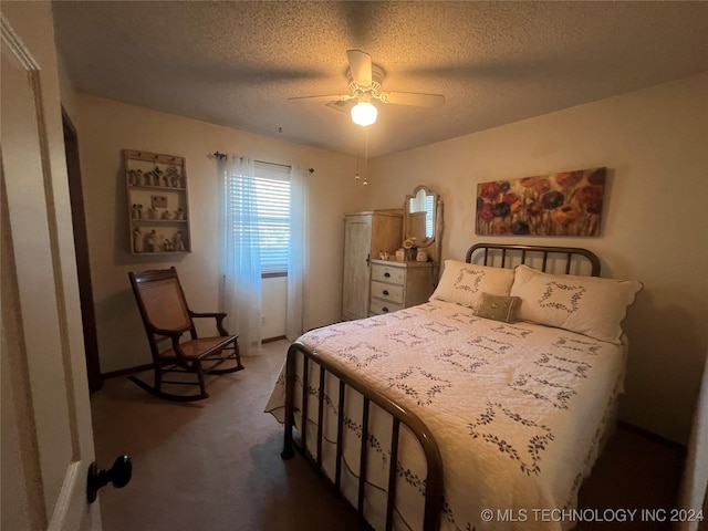 carpeted bedroom featuring ceiling fan and a textured ceiling